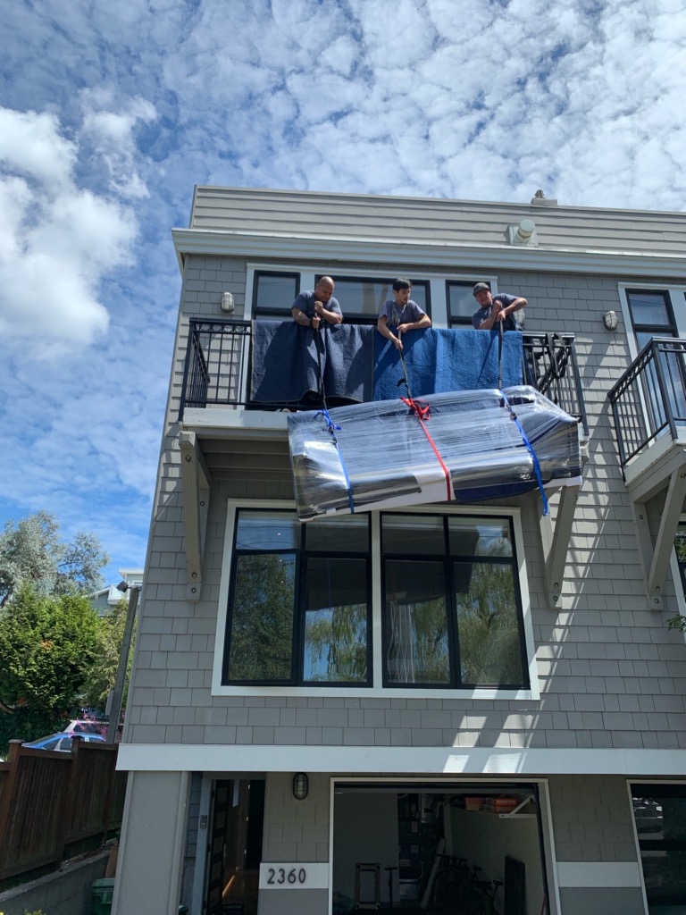 Movers in Seattle lifting a sofa